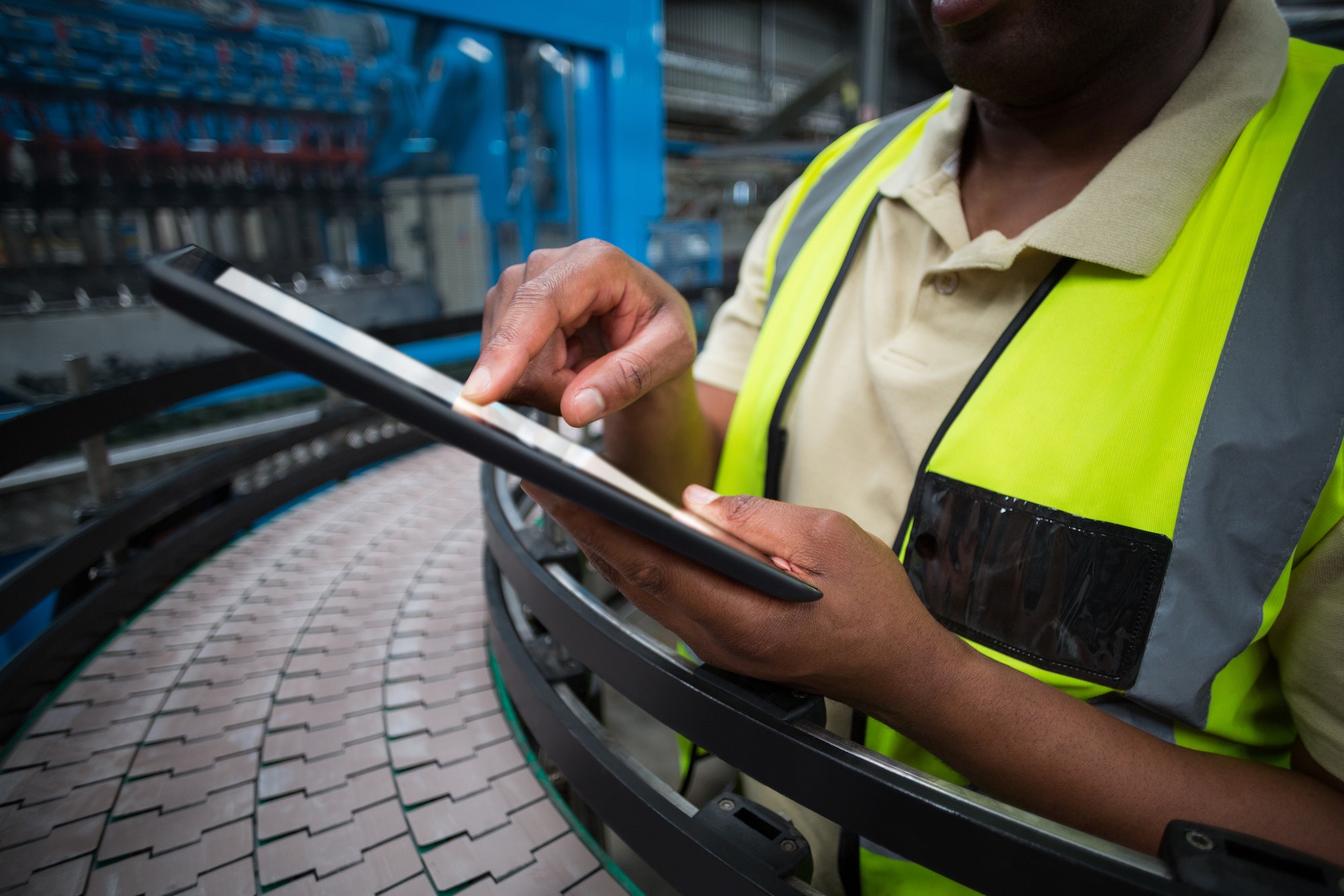 Factory worker using digital tablet in the factory